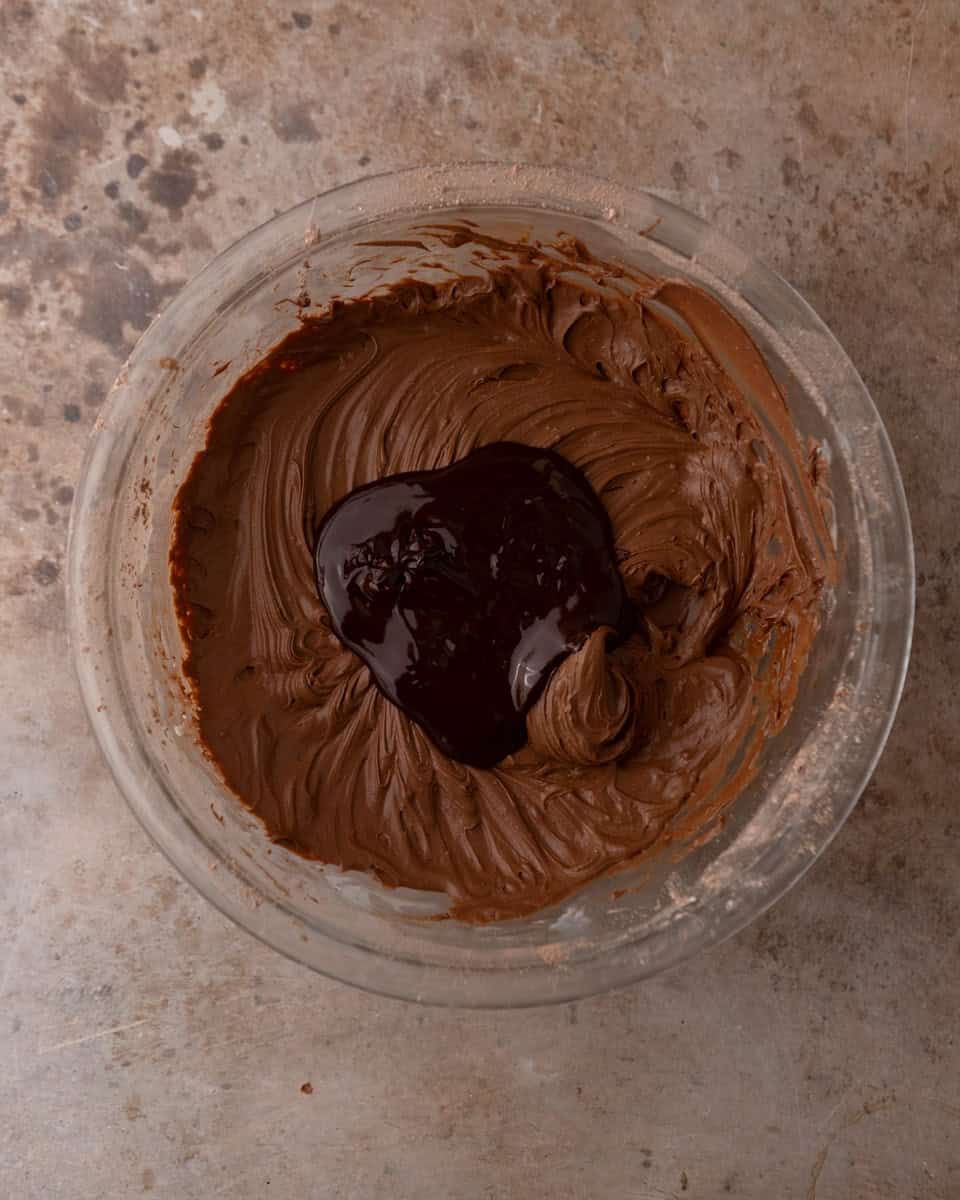 Melted chocolate added to chocolate cream cheese frosting
