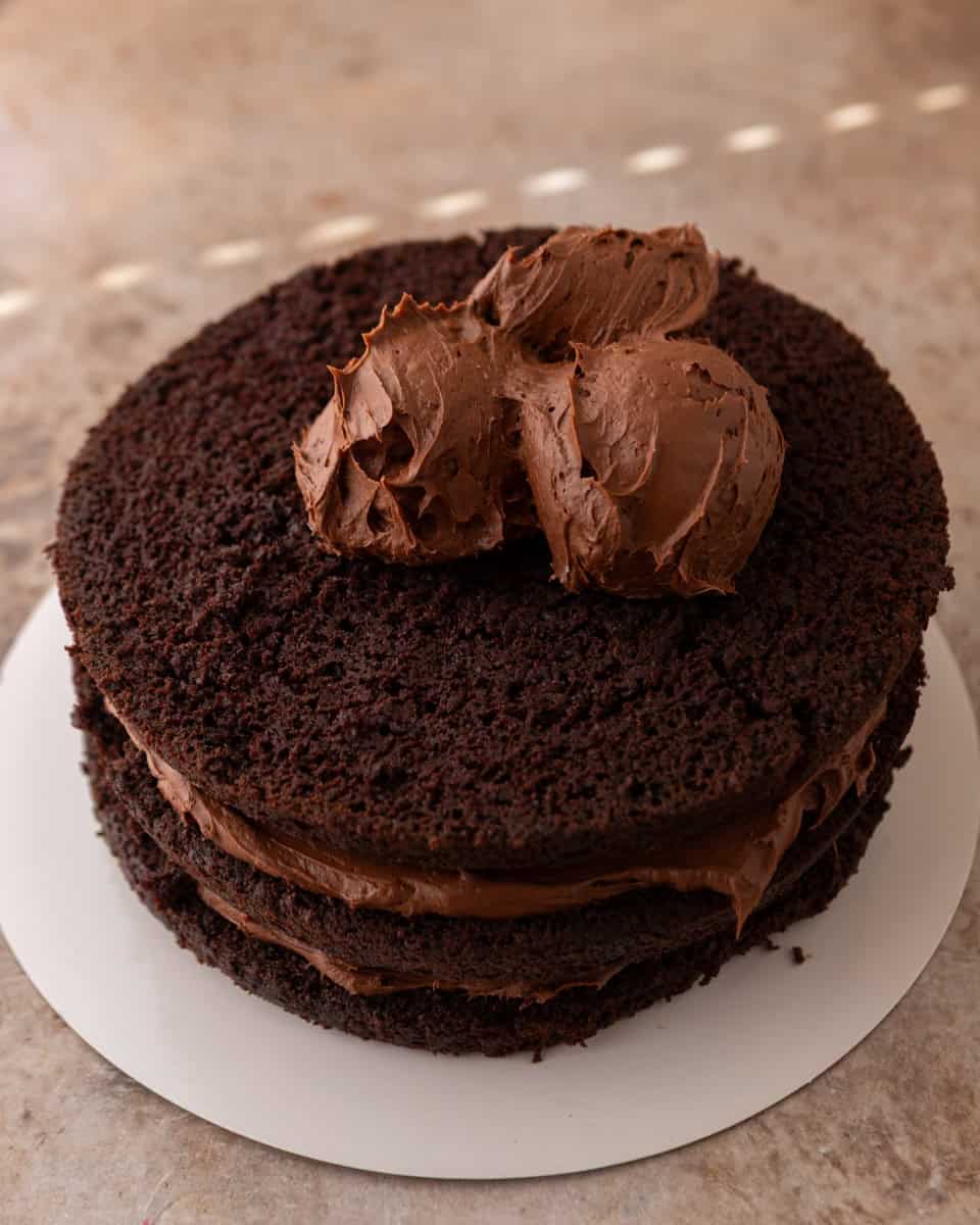 Chocolate beet cake stacked with frosting between the layers

