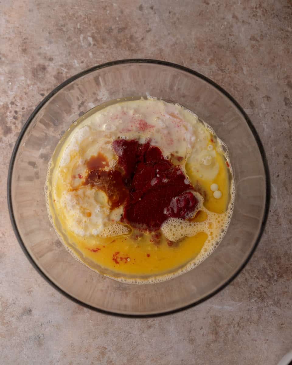 Wet cake ingredients combined in a bowl before mixing
