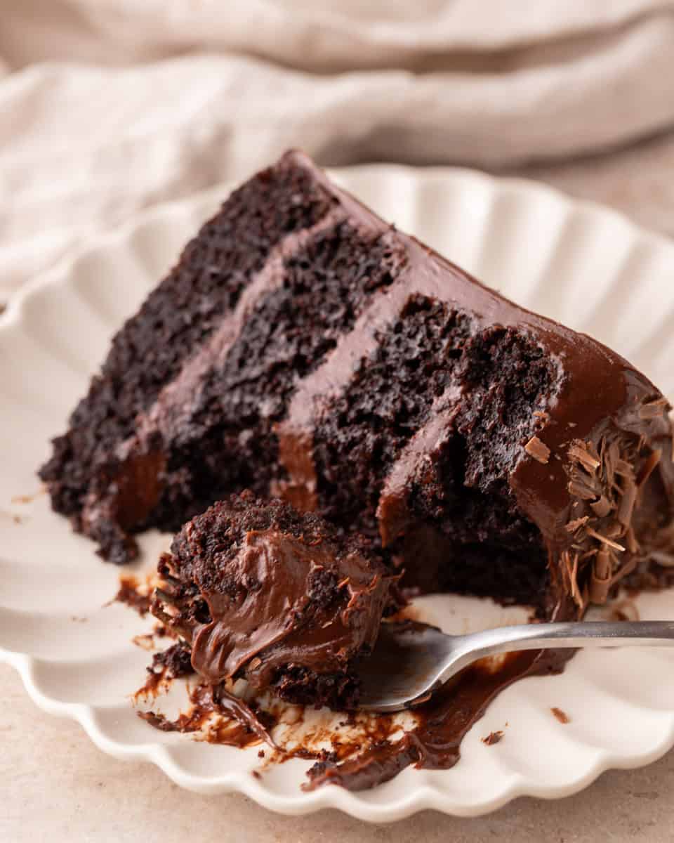 Fork cutting into a slice of fudgy chocolate beet cake
