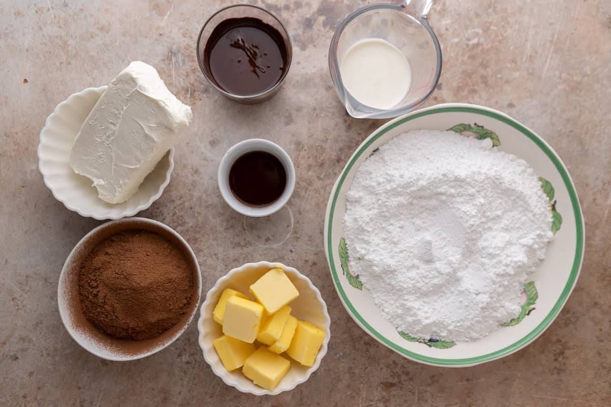 Ingredients for chocolate cream cheese frosting laid out on a counter
