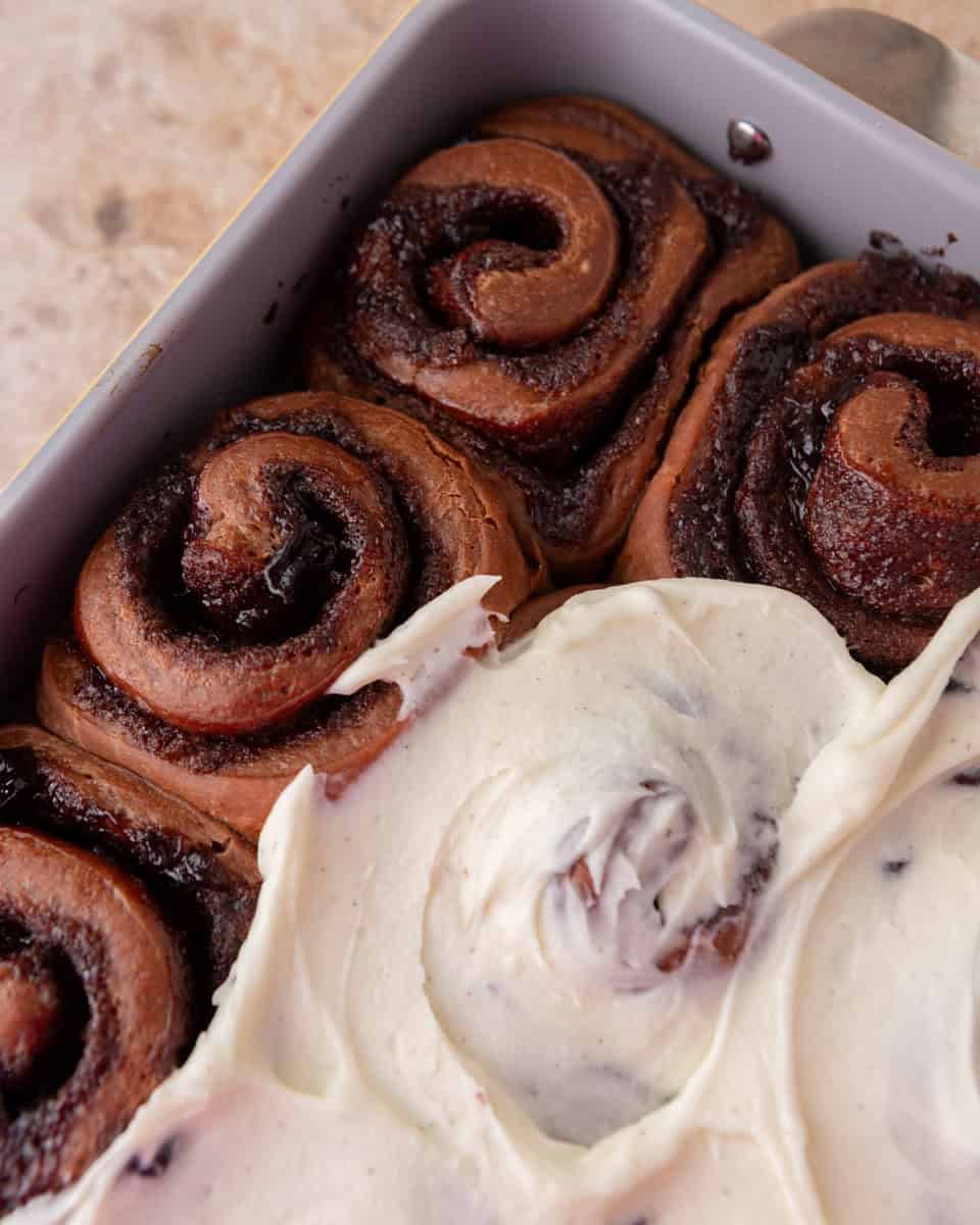 Frosting Black Forest cinnamon rolls with vanilla mascarpone frosting