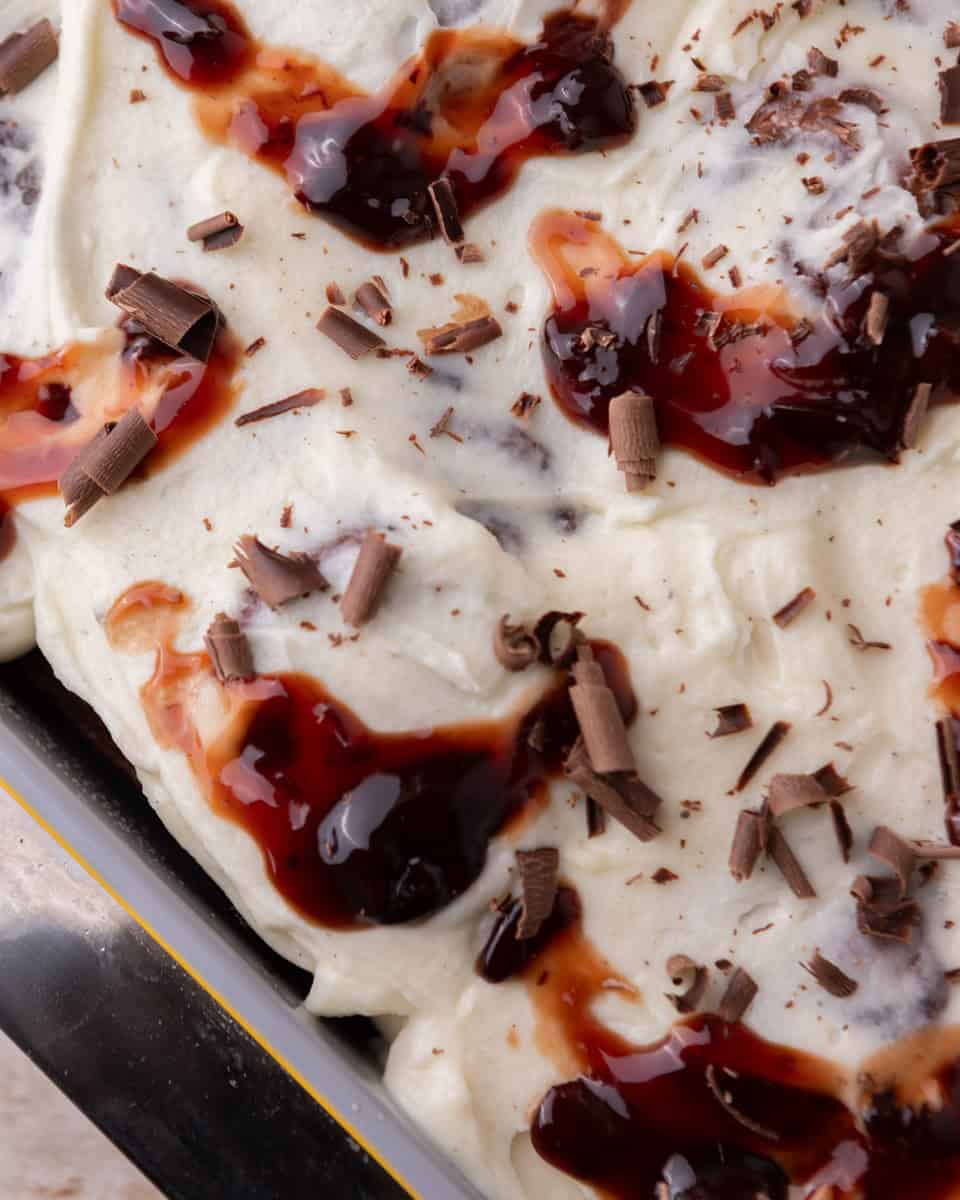 Close up of frosted rolls topped with cherries and chocolate shavings