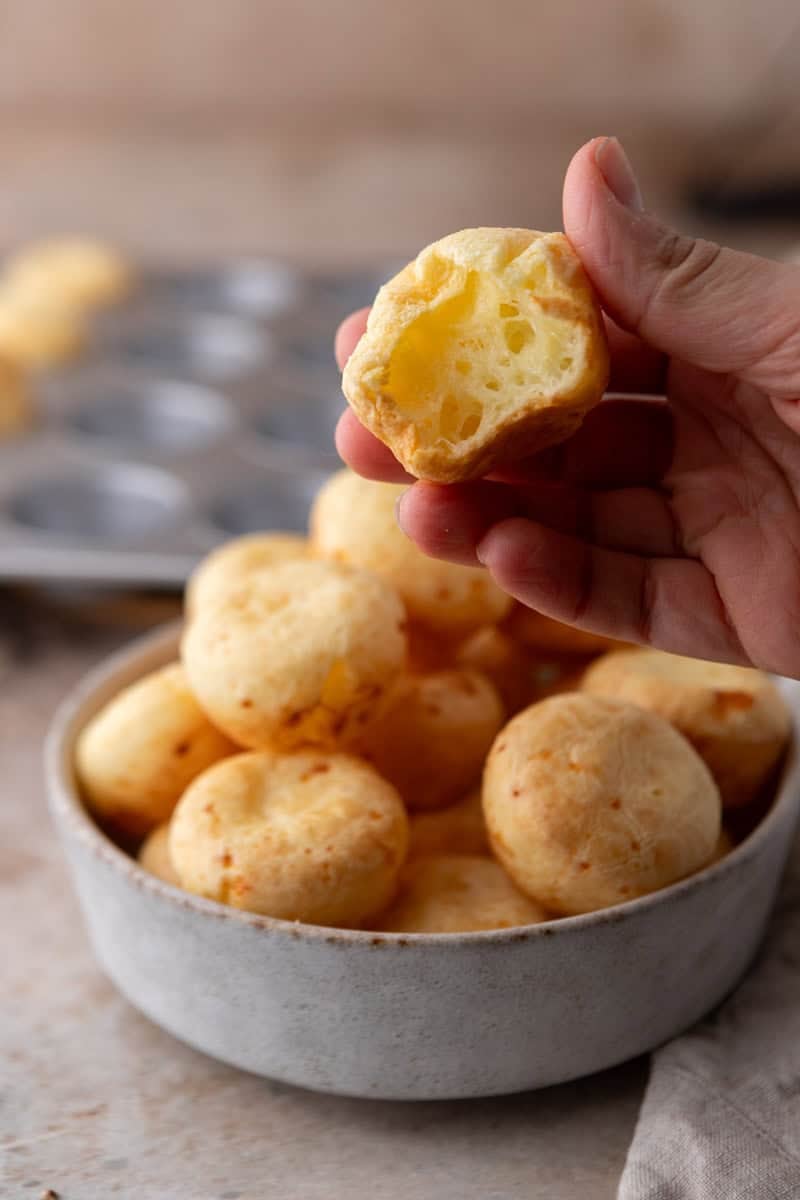 Brazilian cheese bread bite showing hollow, chewy interior