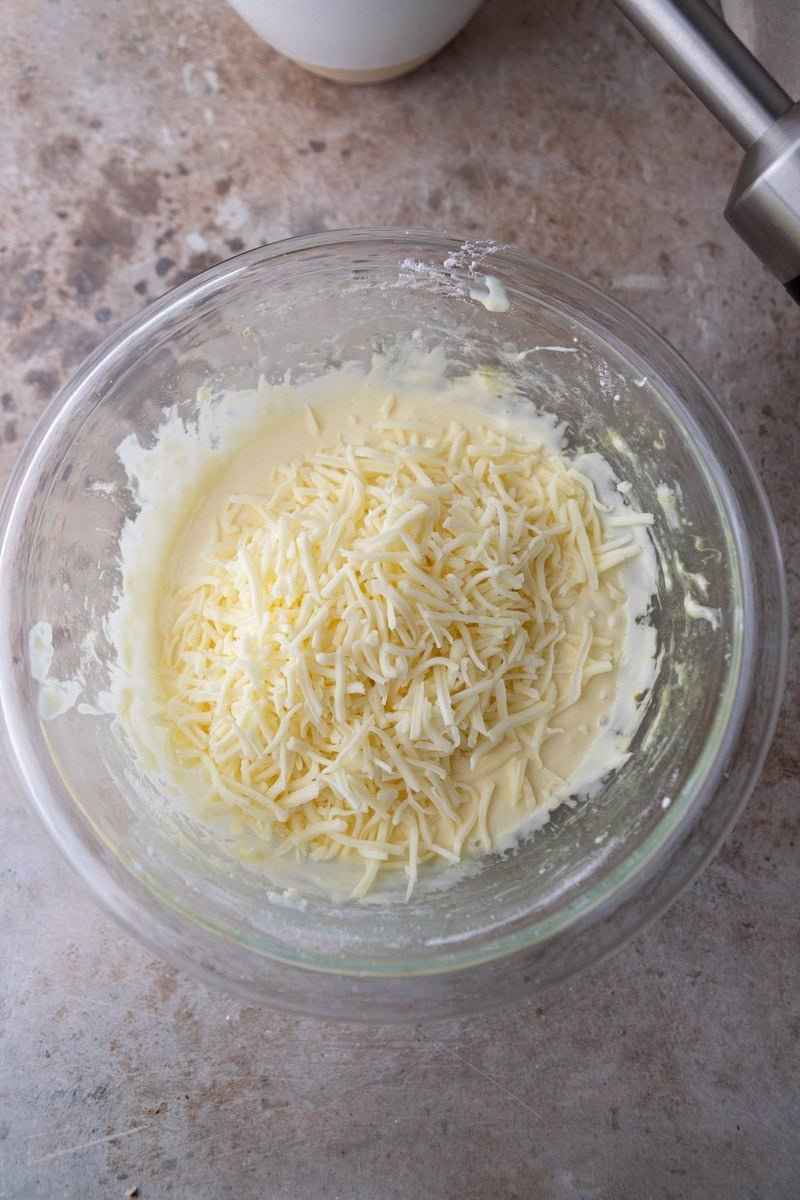 Grated cheese folded into cheese bread batter