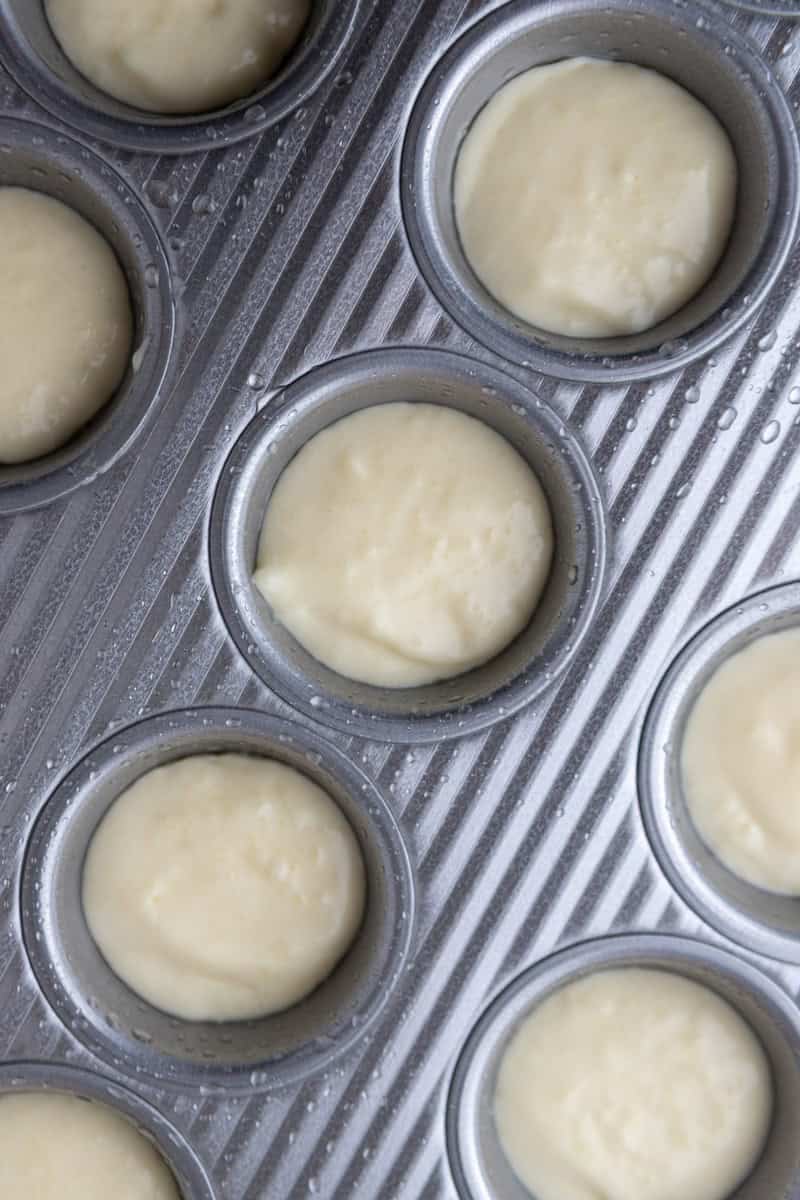 Unbaked Brazilian cheese bread batter portioned in mini muffin tin