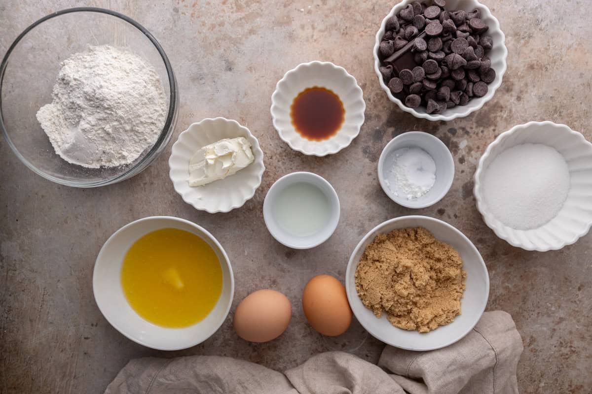 Ingredients for cream cheese chocolate chip cookies arranged on a countertop
