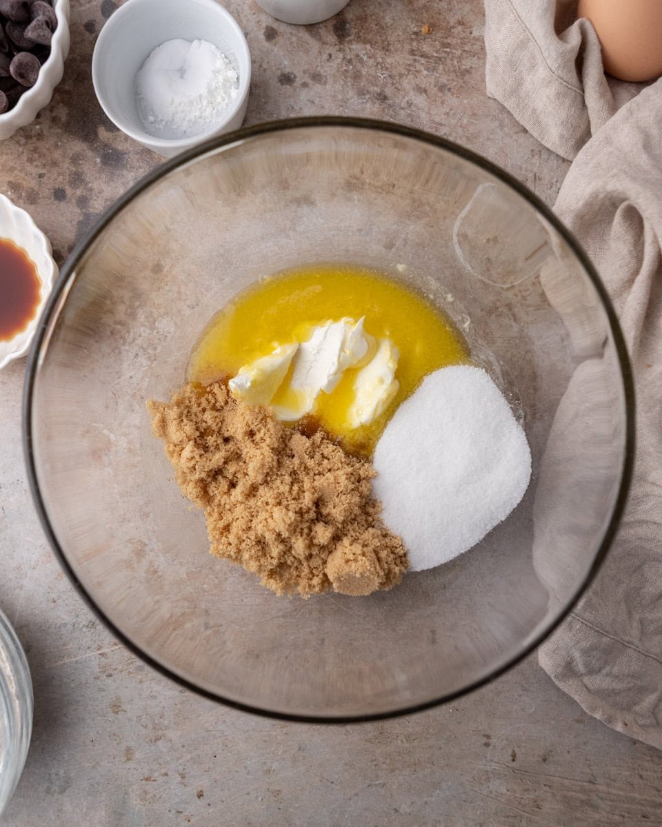 Butter, cream cheese, and sugars combined in a bowl for cream cheese chocolate chip cookies
