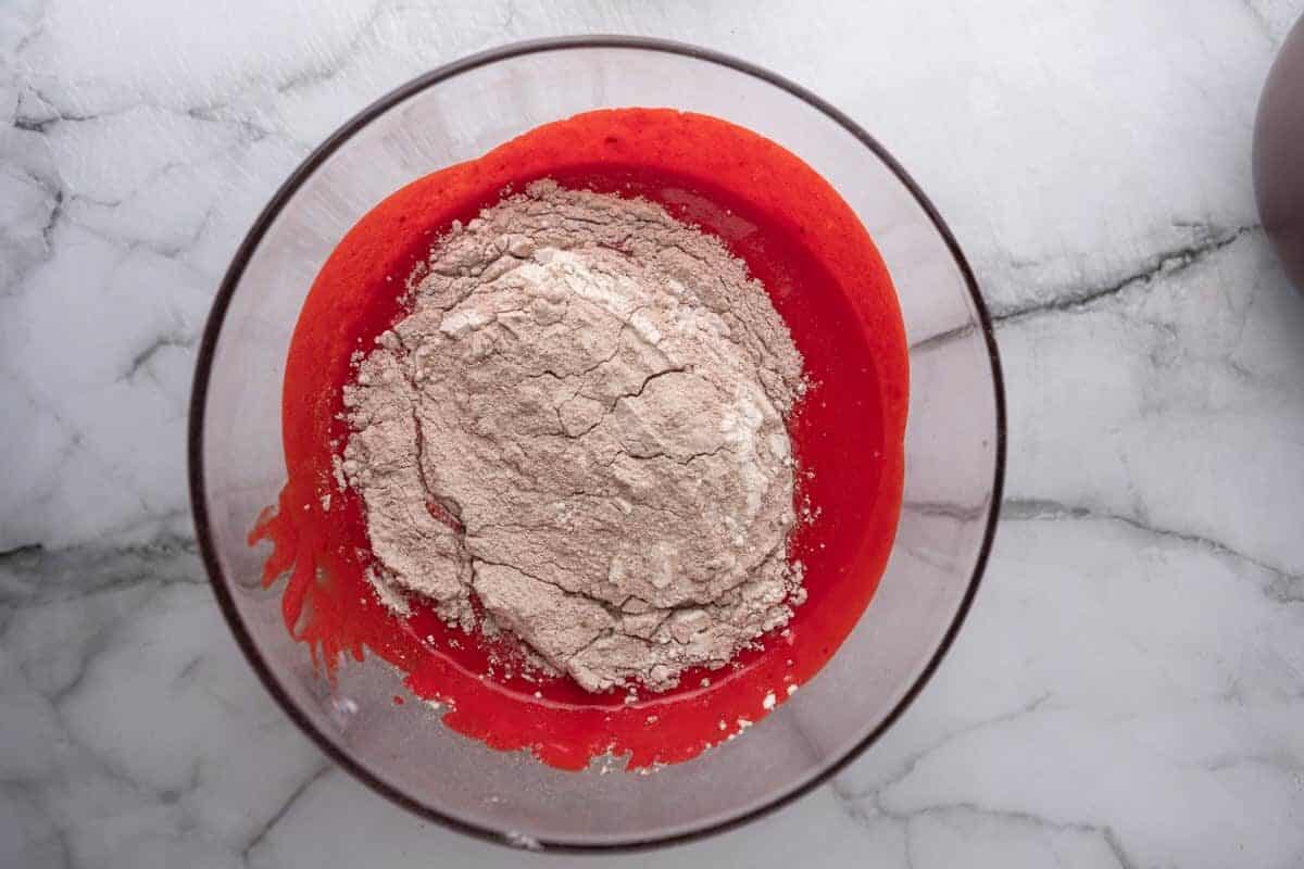 dry ingredients added to cake batter in mixing bowl