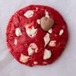 Single serve red velvet cookie with white chocolate chunks and a glossy cracked top