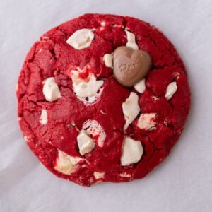 Single serve red velvet cookie with white chocolate chunks and a glossy cracked top