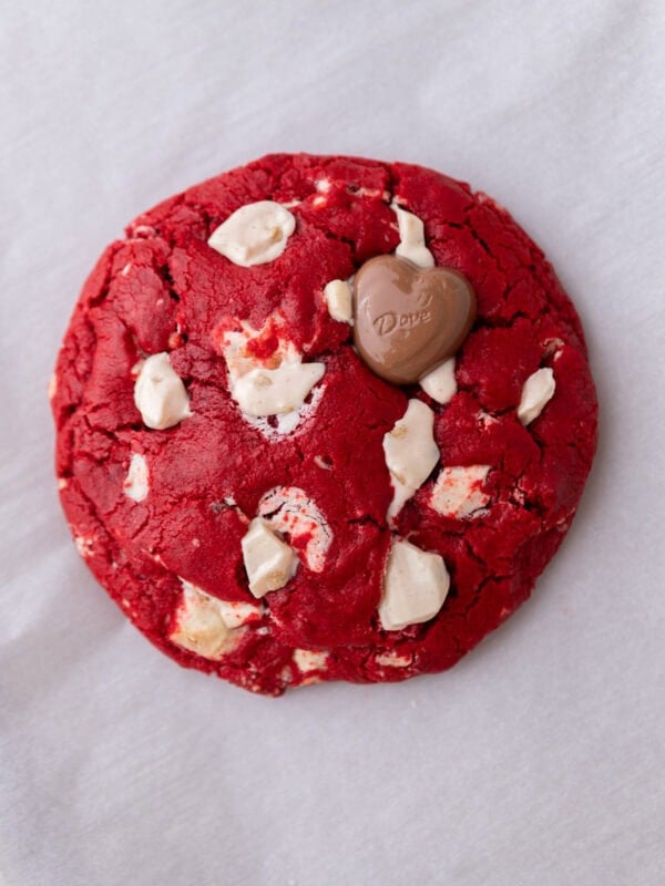 Single serve red velvet cookie with white chocolate chunks and a glossy cracked top