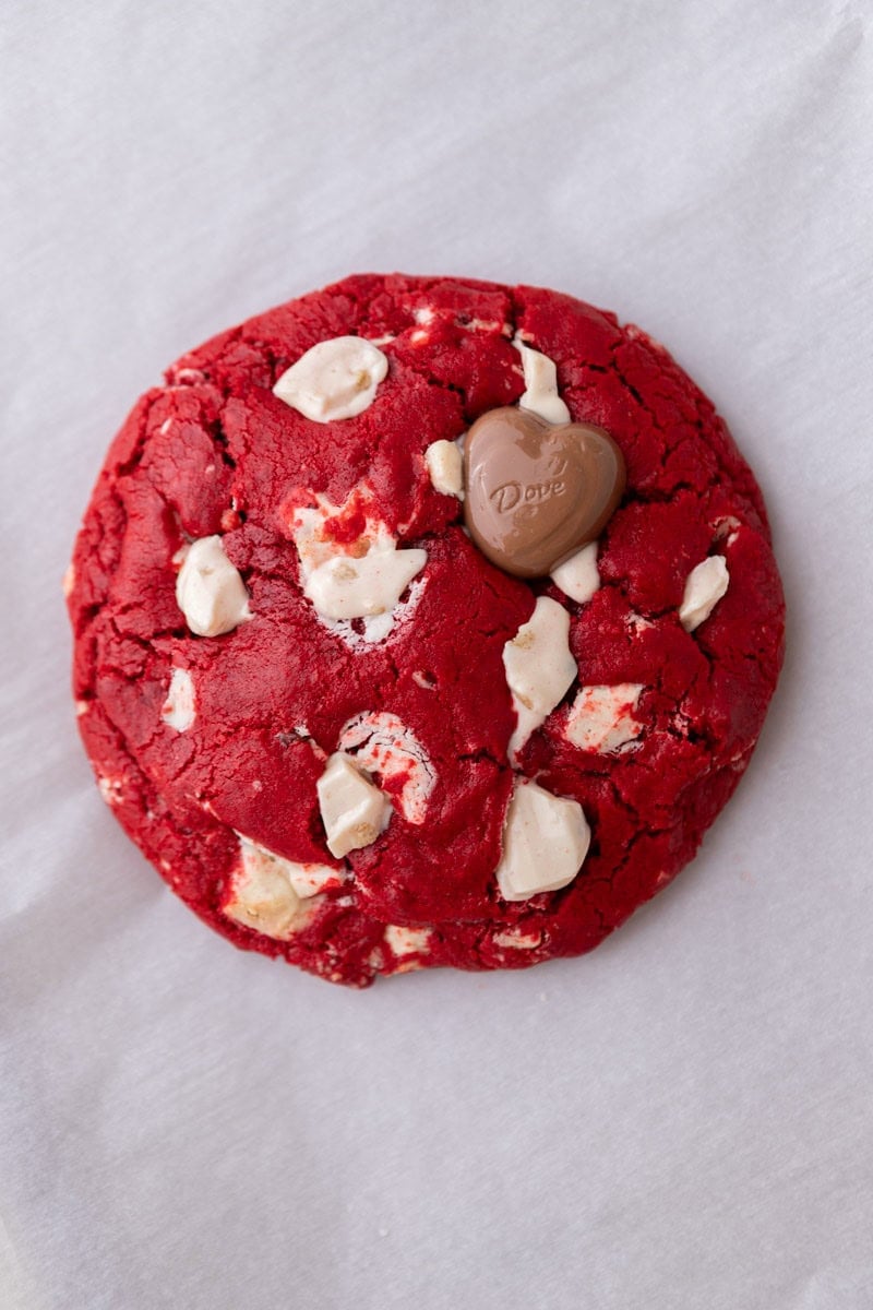 Single serve red velvet cookie with white chocolate chunks and a glossy cracked top