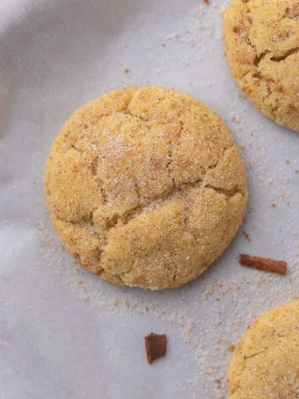 Baked small-batch snickerdoodle cookie cooling on parchment paper
