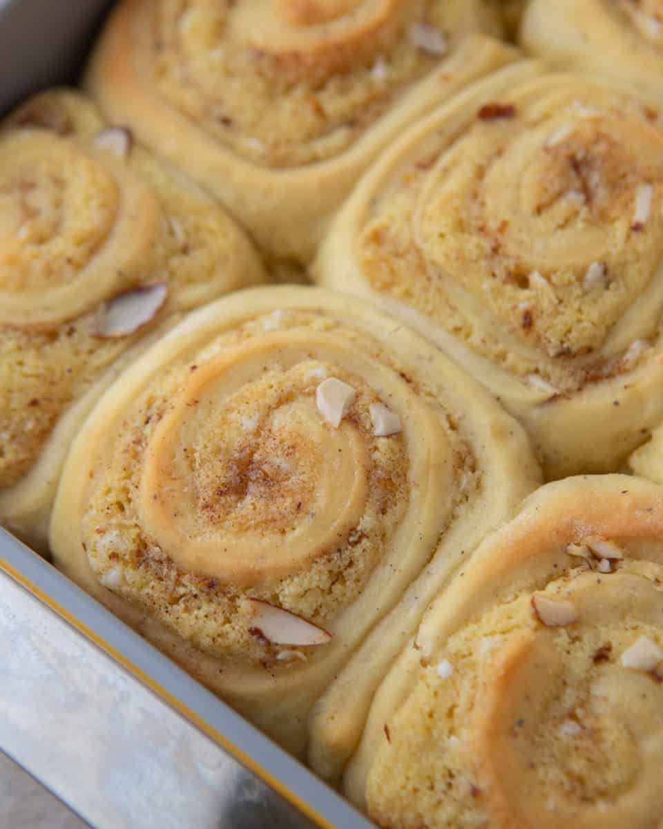 almond croissant cinnamon rolls before frosting in a baking pan