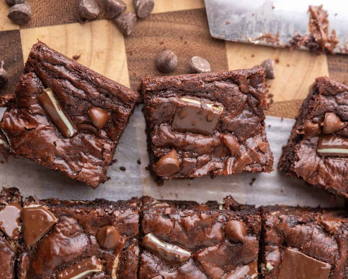 Freshly baked Andes Mint brownies cut into squares showing shiny crackly tops