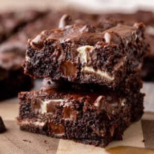 Andes mint brownies stacked to show fudgy centers with melted chocolate chunks