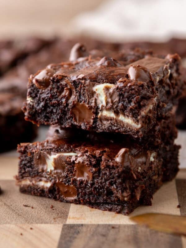 Andes mint brownies stacked to show fudgy centers with melted chocolate chunks