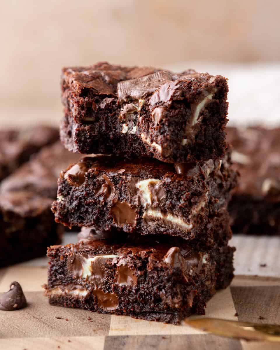 Andes mint brownies stacked to show fudgy centers with melted chocolate chunks