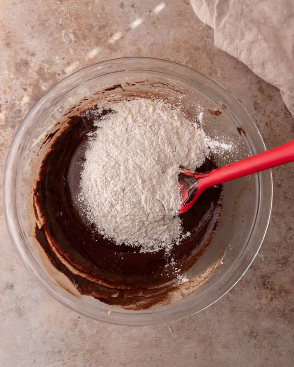 Flour added to chocolate brownie batter before folding