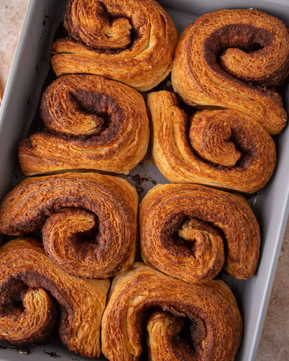 Deep golden croissant cinnamon rolls baked with flaky laminated layers