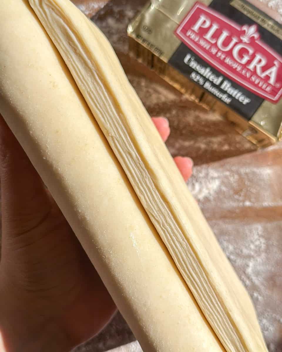Cross section of laminated croissant dough showing multiple thin butter layers