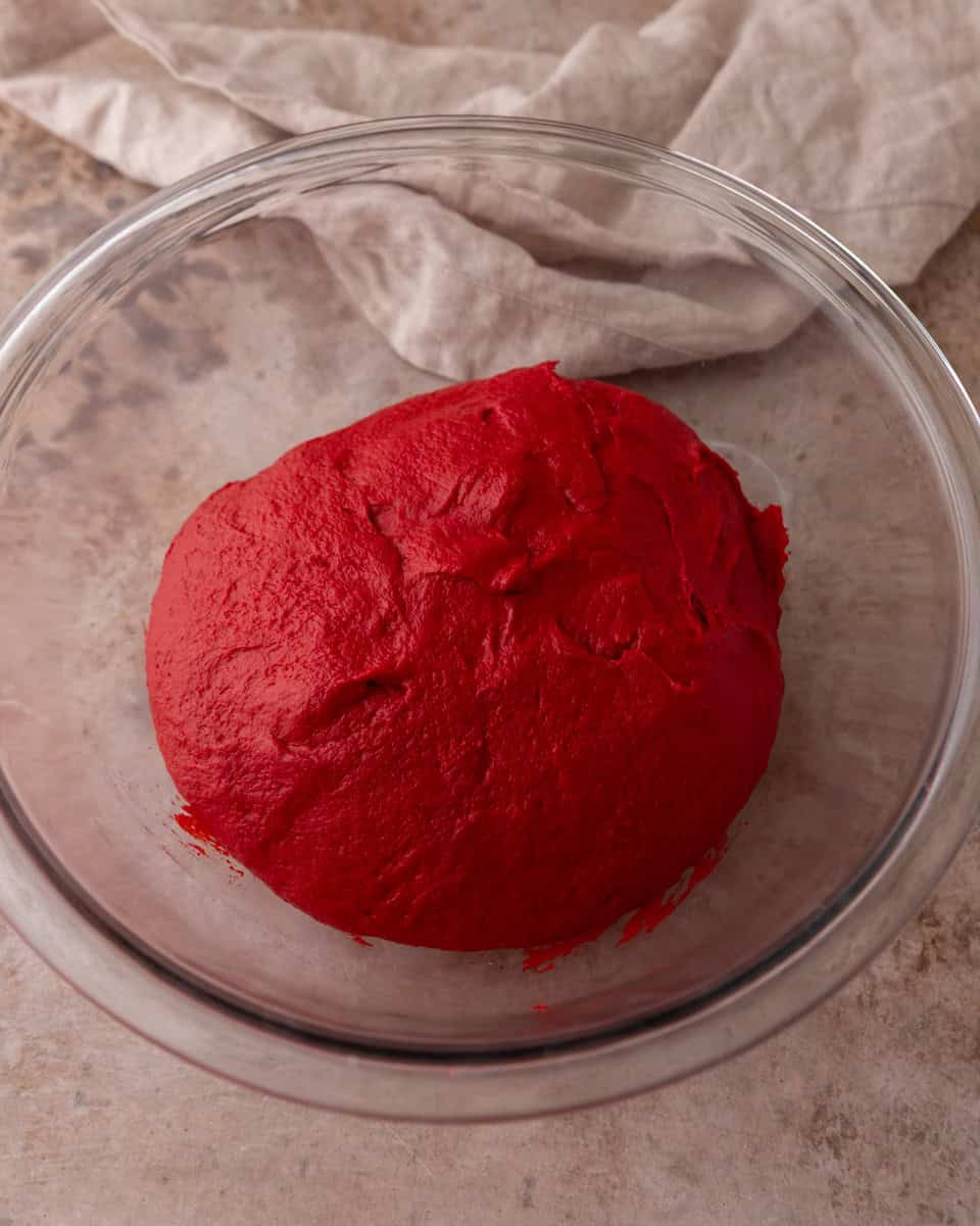 Smooth dough resting in a glass bowl before rising