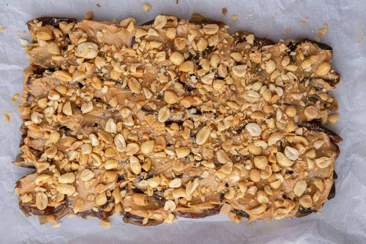 Chopped peanuts sprinkled over peanut butter date layer