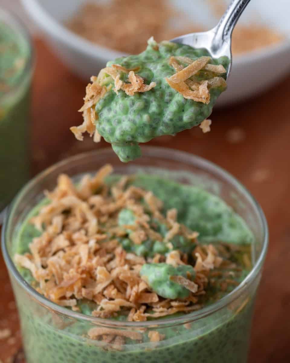 Spoonful of creamy matcha chia pudding showing thick pudding texture