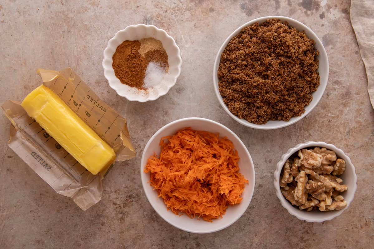 Ingredients for roll filling including brown sugar, shredded carrots, butter, walnuts, and spices