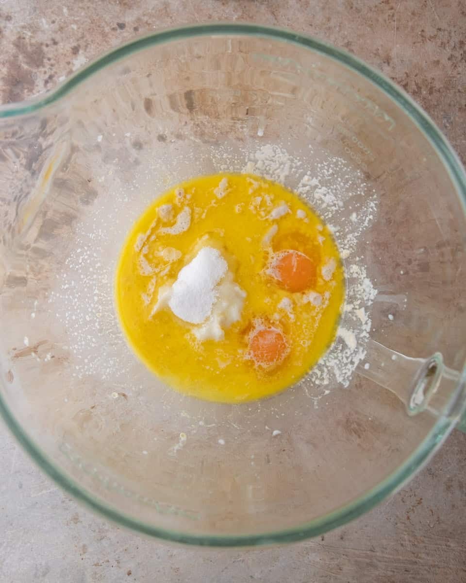 Melted butter, eggs, sugar and salt combined in a glass bowl to start the brioche dough