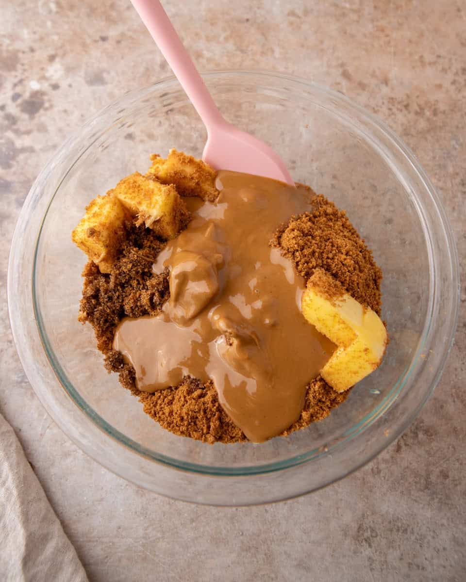 Cookie butter, brown sugar and butter in a glass bowl before mixing the cinnamon roll filling
