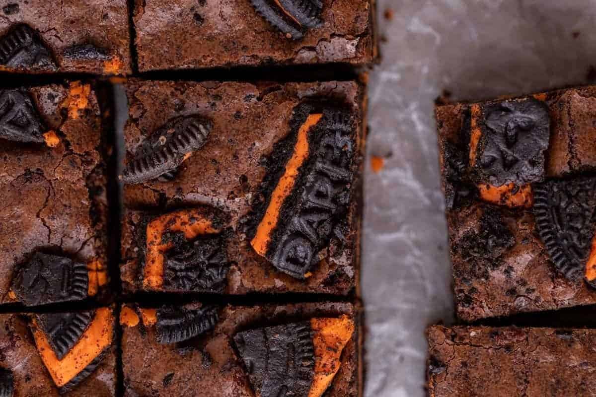Overhead view of Halloween Oreo brownies sliced into squares with orange Halloween Oreo cookies baked into the fudgy brownie top