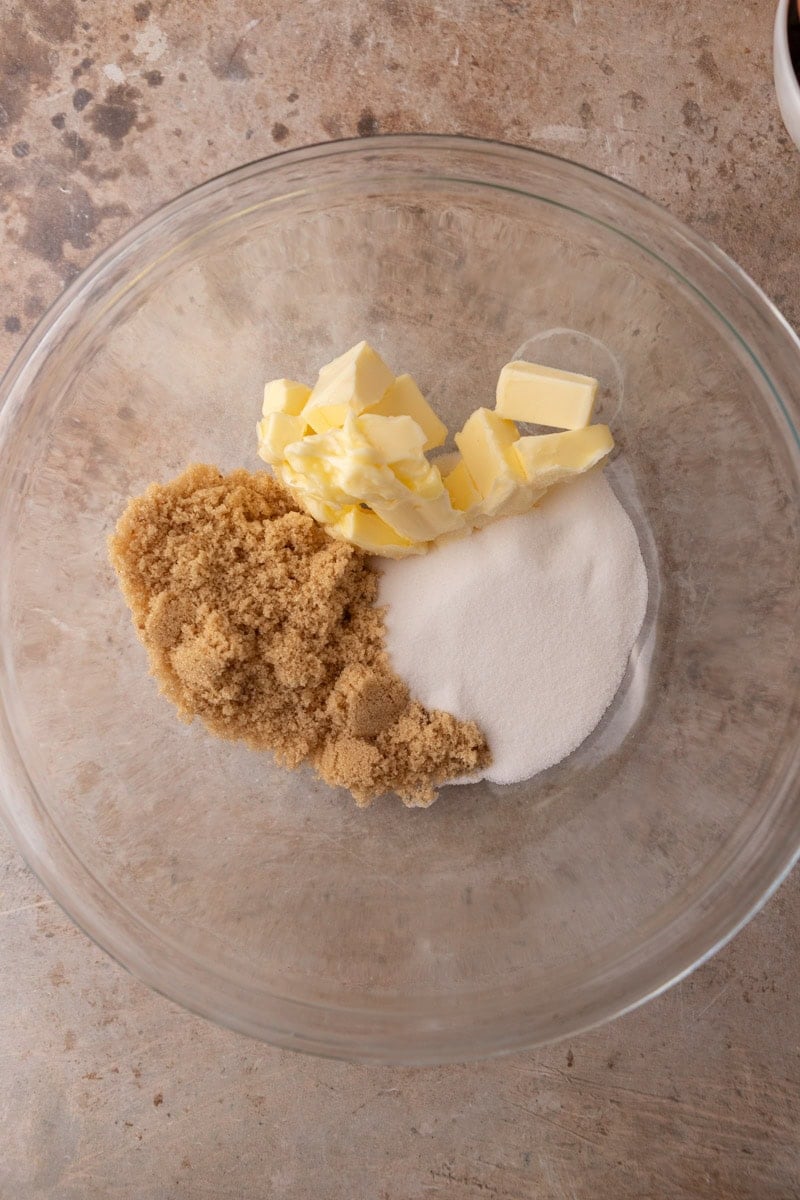 Softened butter, brown sugar, and granulated sugar in a glass mixing bowl before creaming