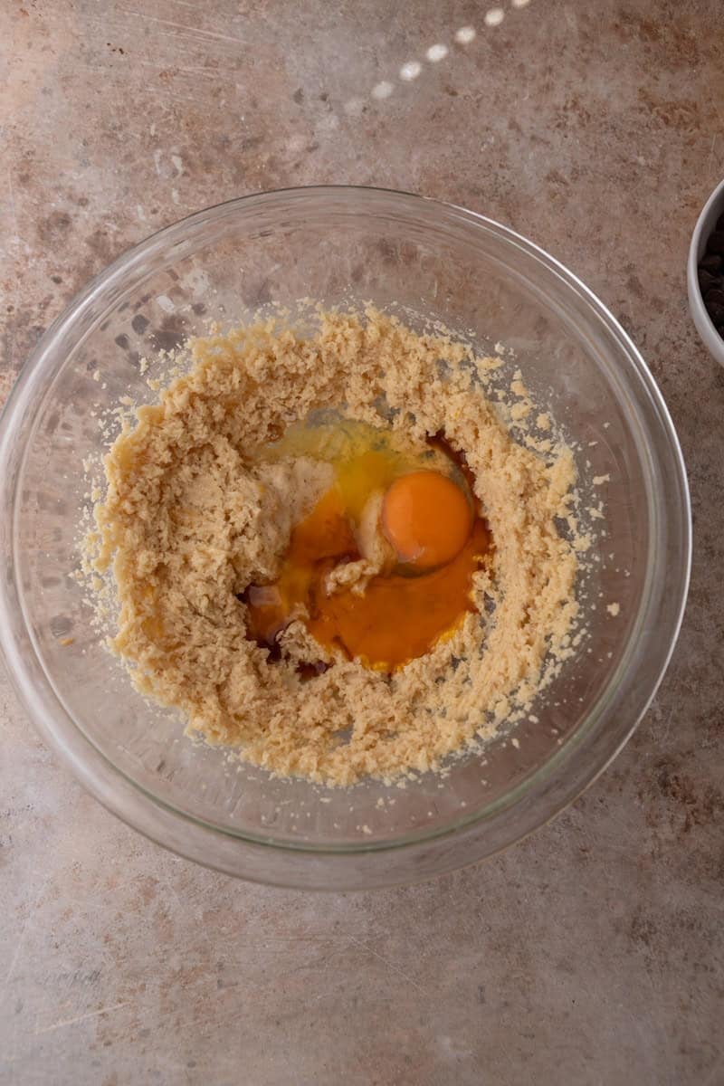 Creamed butter and sugar mixture with an egg and egg yolk added to the bowl