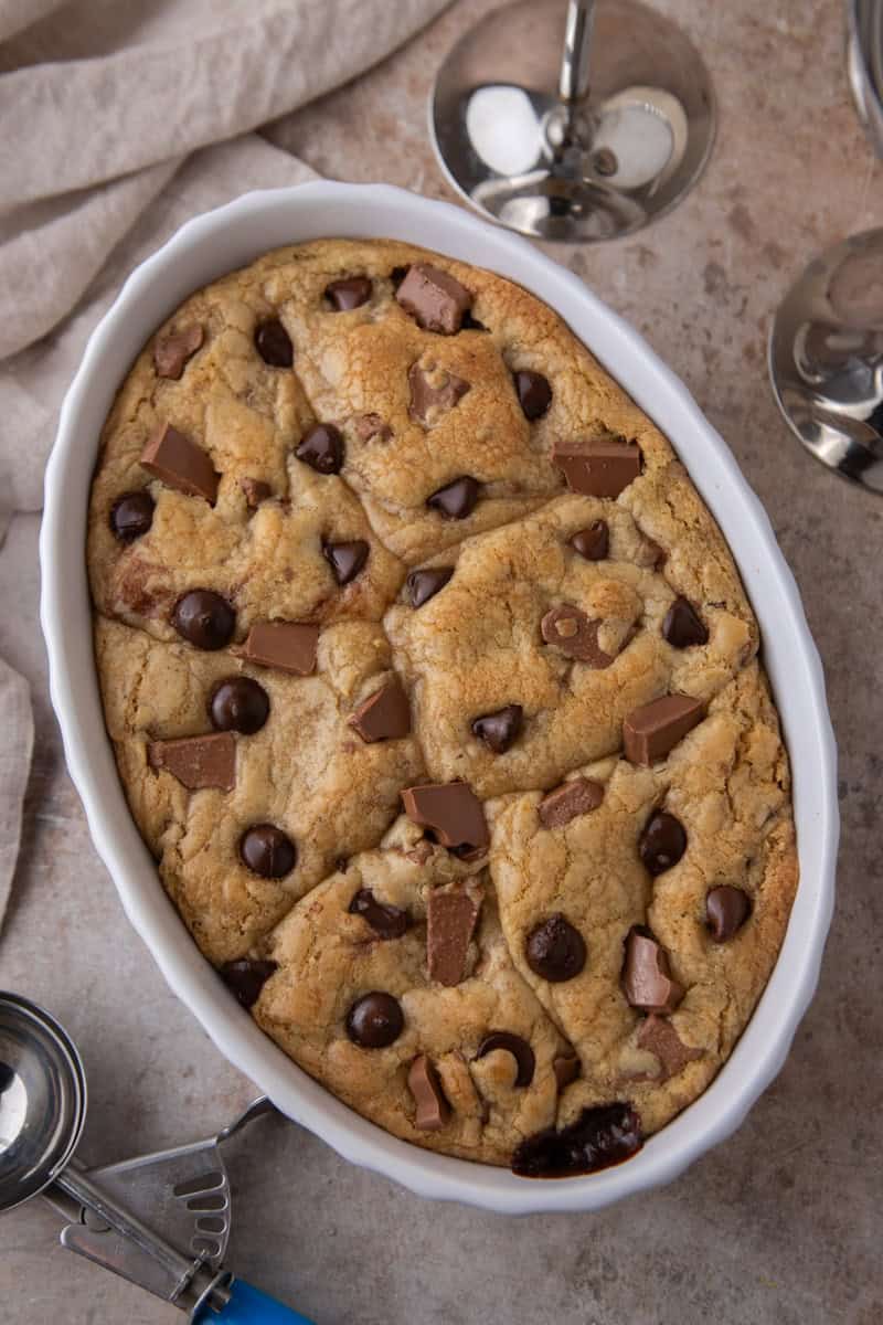 Golden brown chocolate chip cookies baked together in a ceramic baking dish