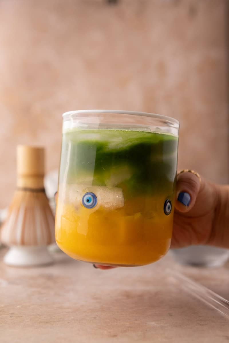 mango matcha drink with coconut water showing layered marble effect