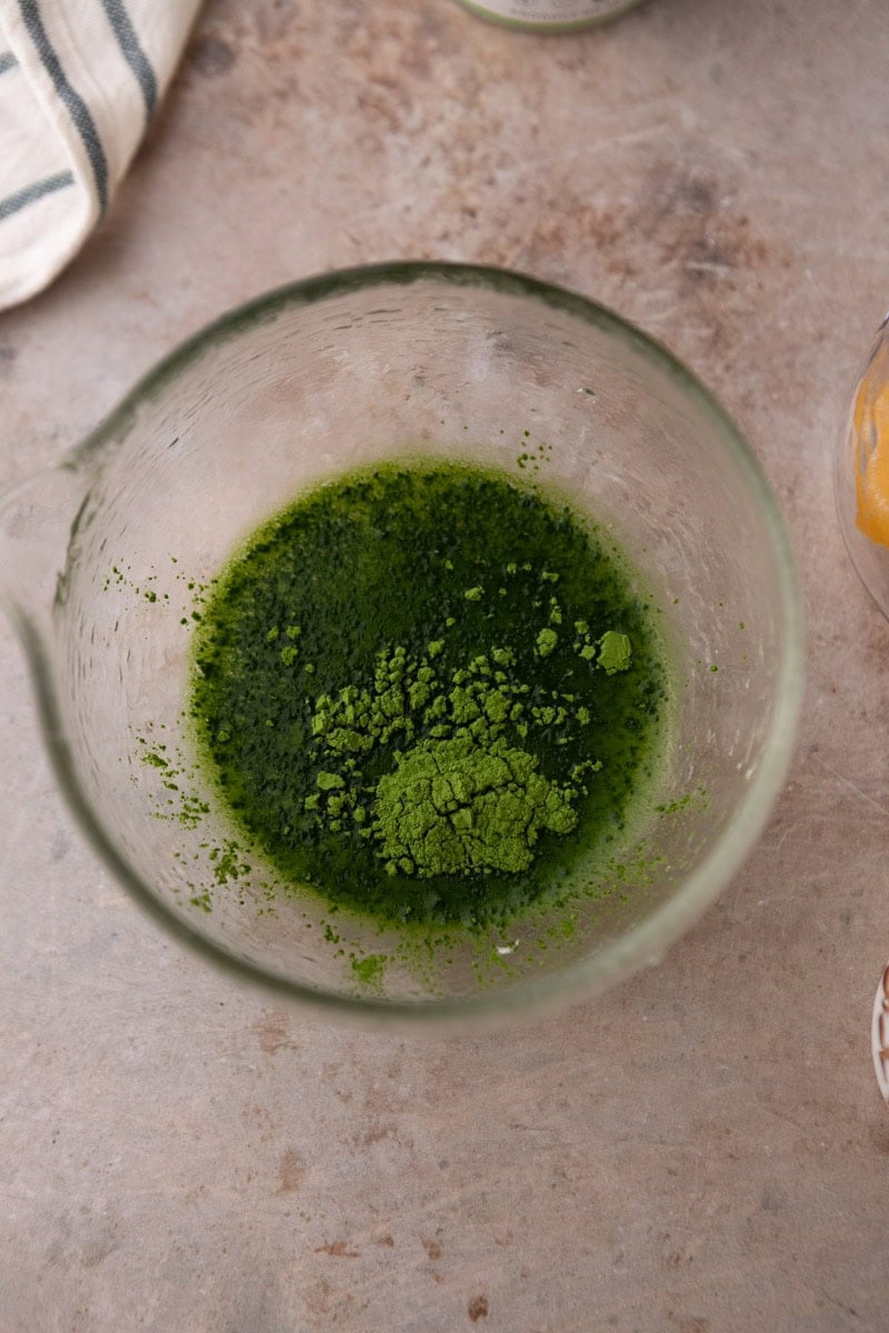 matcha powder in a glass bowl before whisking with hot water