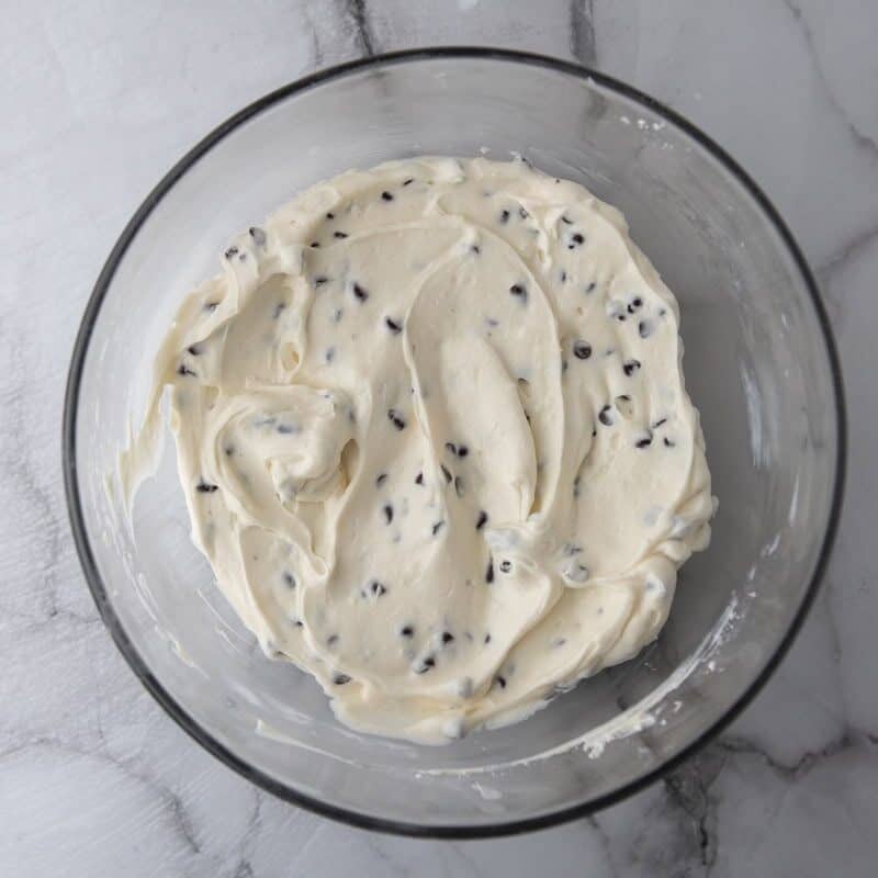 Finished dip, whipped until lofty and studded with mini chocolate chips. Chilling the dip allows it to set up to a scoop-able consistency perfect for dipping.