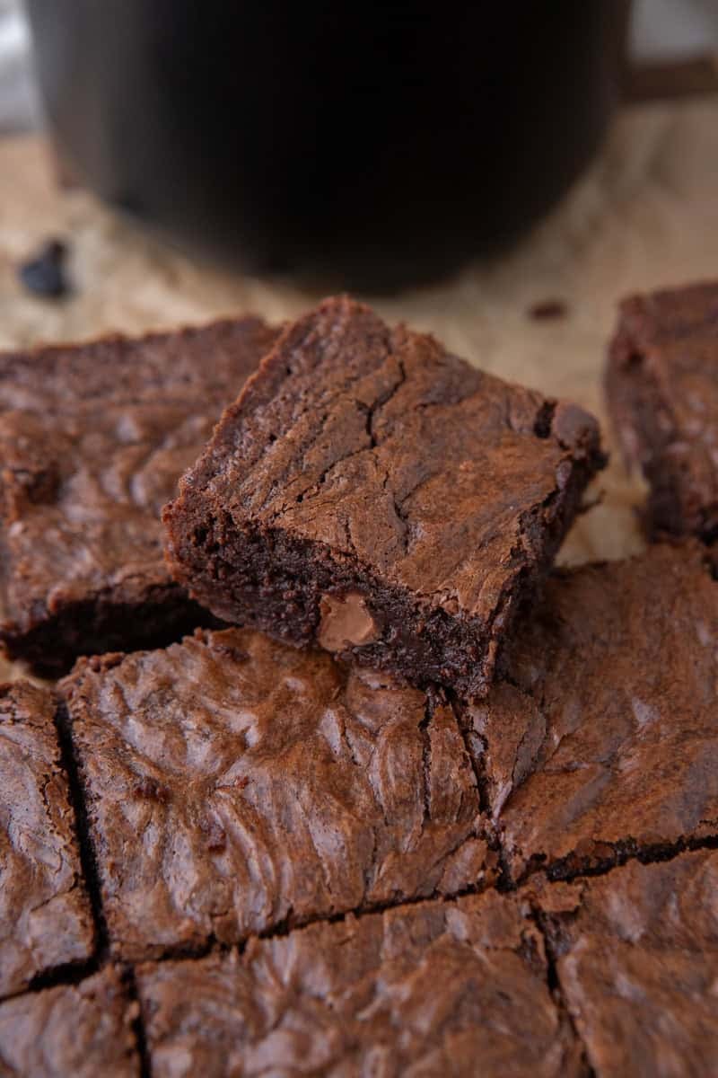 Sliced fudgy coffee brownies with one piece tilted up showing the chewy dense interior