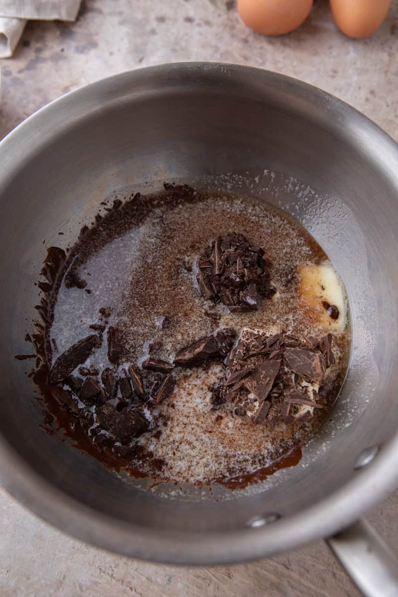 Chopped dark chocolate and butter in a stainless steel saucepan before melting