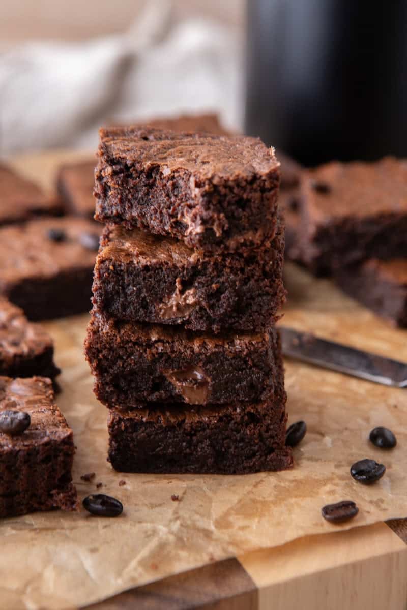 Stack of three chocolate coffee brownies showing dense fudgy centers