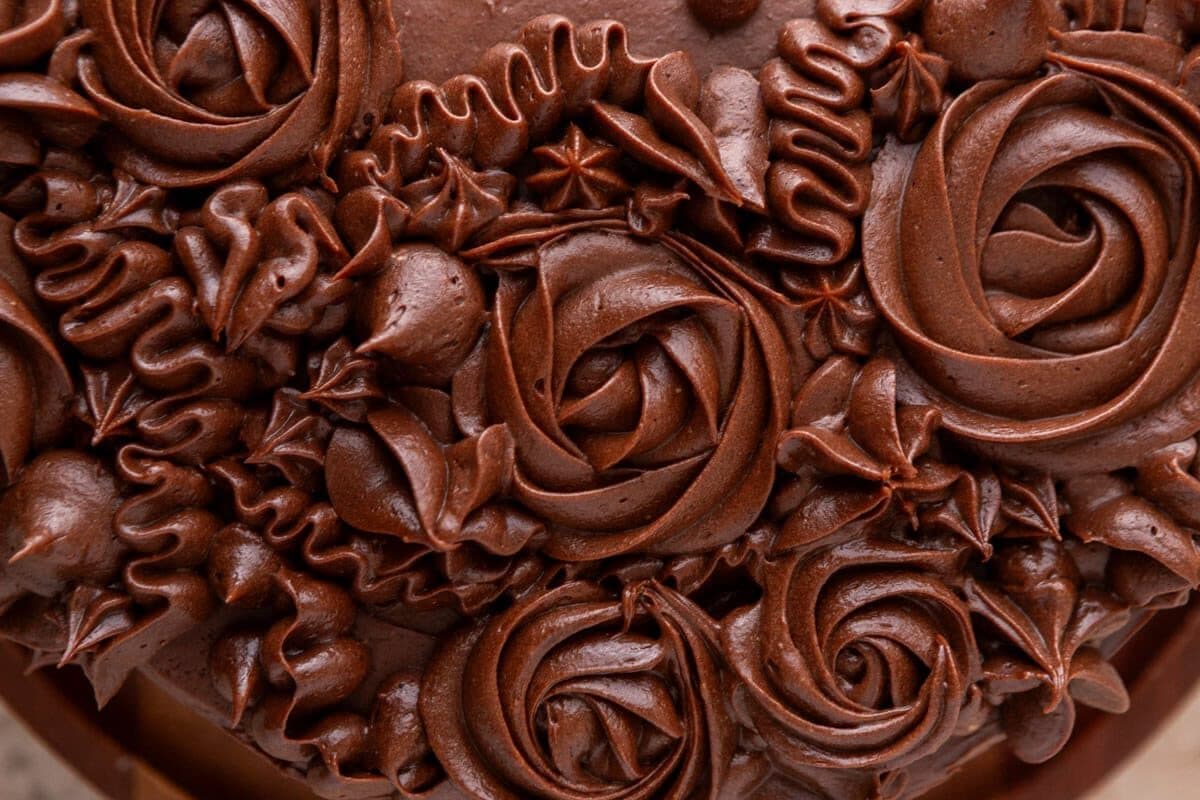 Close-up of smooth, silky chocolate cream cheese frosting showing the creamy, fudgy texture