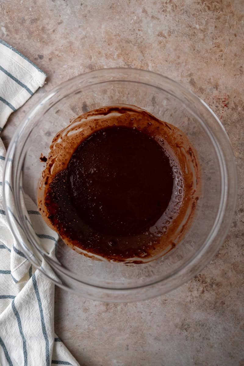 Dutch-process cocoa powder bloomed in hot coffee to make a smooth chocolate paste in a glass bowl
