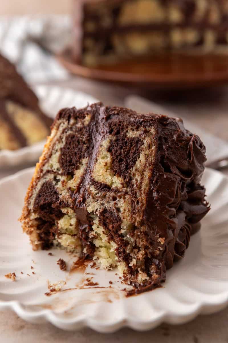 Close-up of a marble cake slice showing the moist crumb and bold chocolate and vanilla swirl pattern