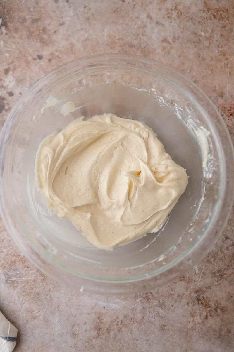 Overhead image showing cream cheese frosting whipped to perfection with vanilla beans mixed in there.