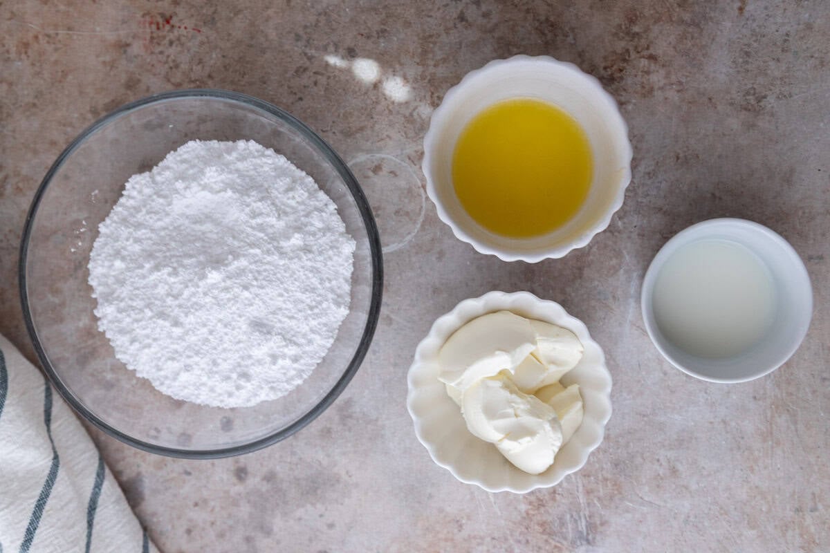 Cream cheese glaze ingredients including powdered sugar, melted butter, cream cheese, and milk