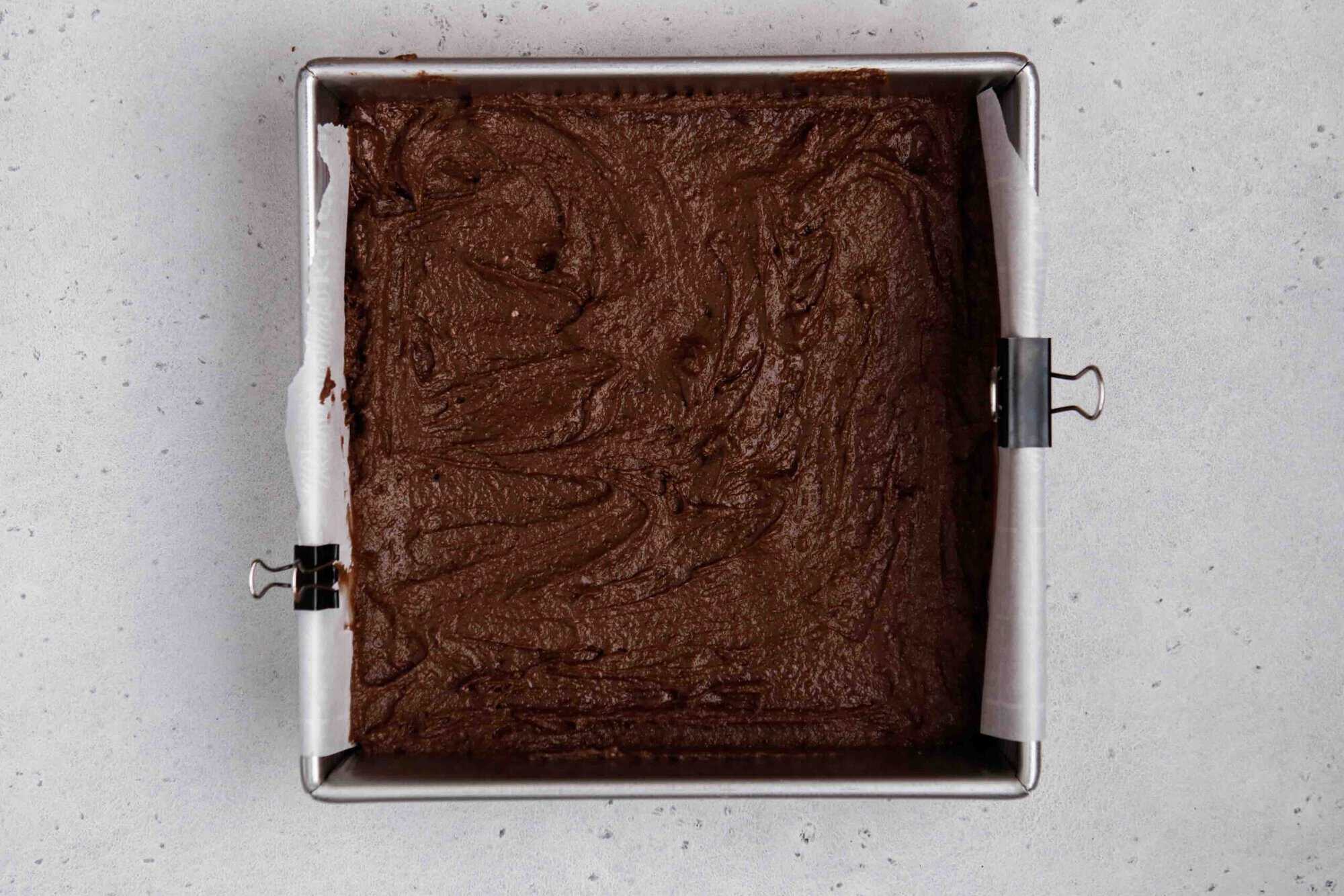 Brownie batter in a 8x8 inch pan before baking