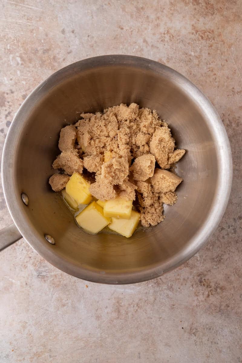 Butter and brown sugar in a saucepan before melting for the salted caramel toffee layer.