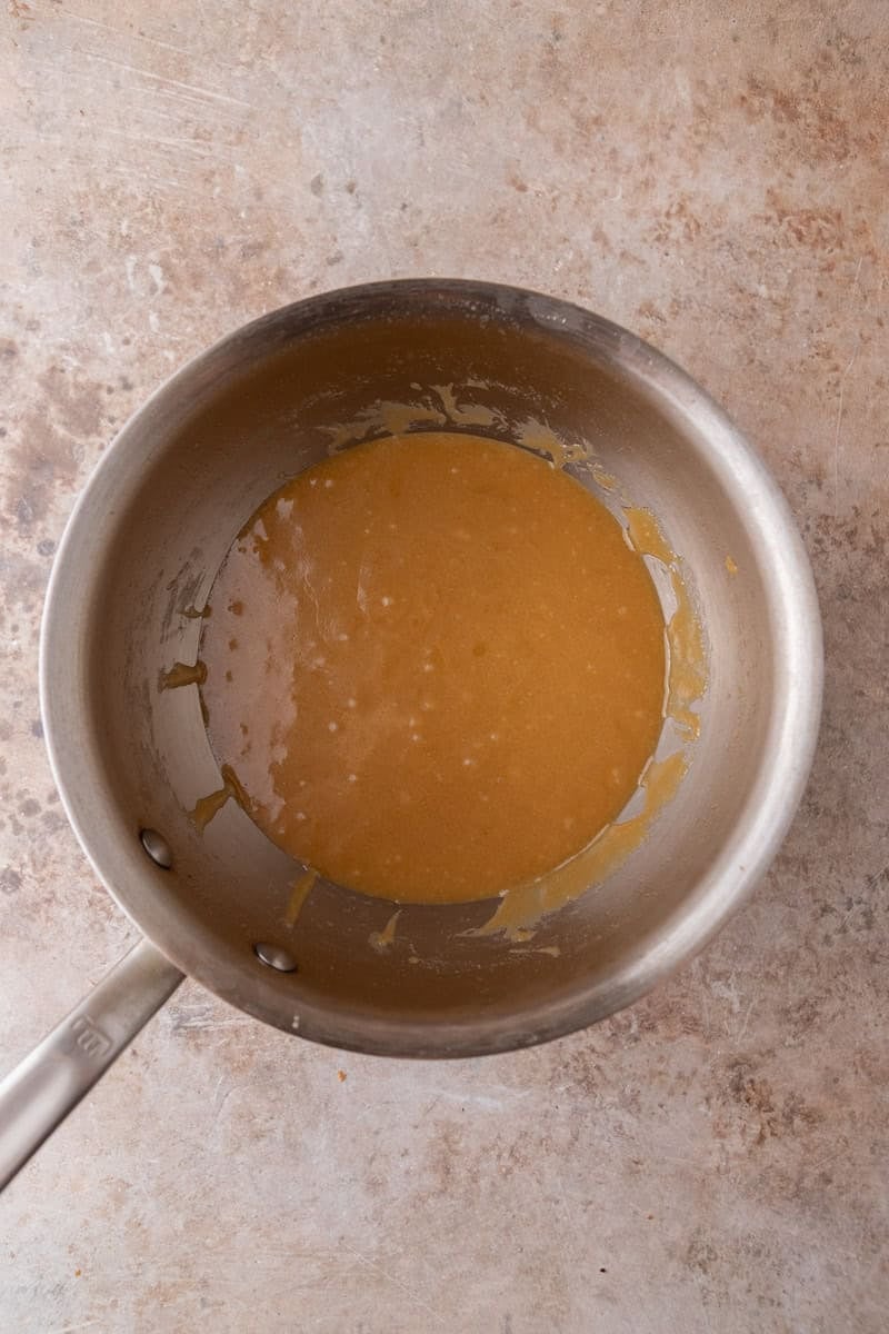 Cooked salted caramel toffee in a saucepan, amber in color and ready to pour.